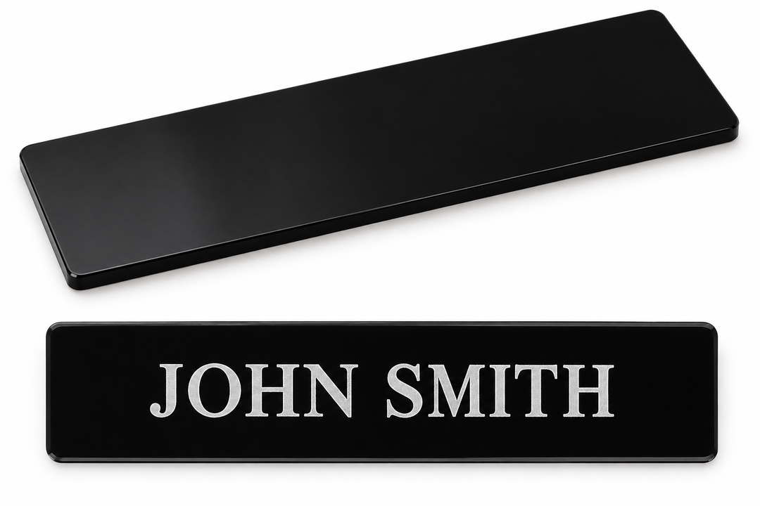 Illustrative black acrylic nameplates, blank and engraved sample. Actual finish and dimensions subject to confirmation.
